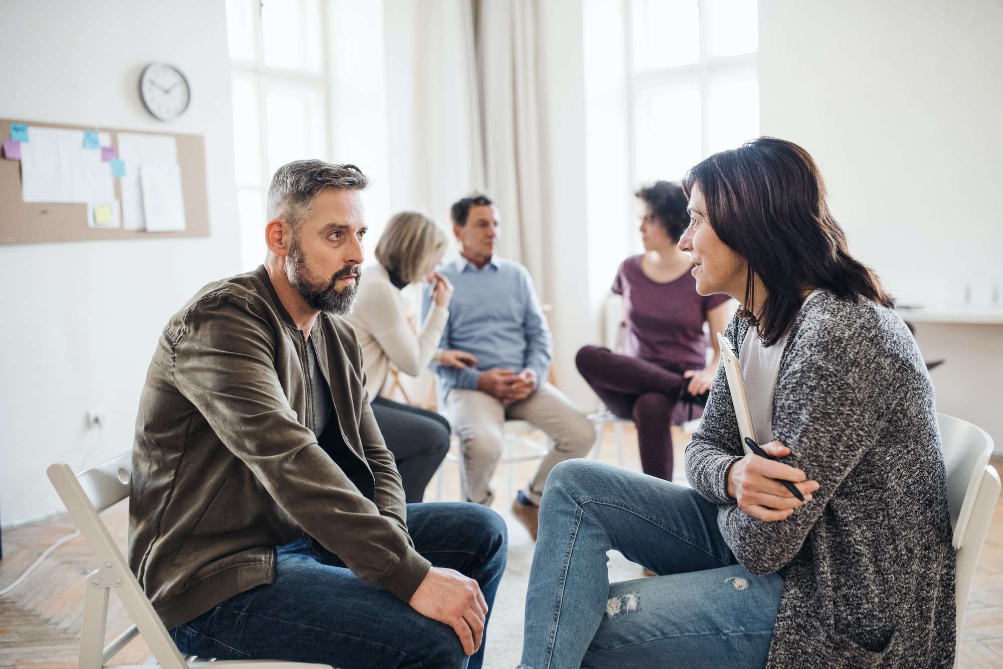 Psychologist in a therapy session with a man with depression