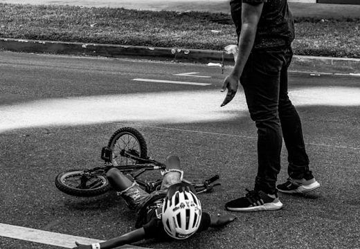 Child learning to ride a bike but has fallen off