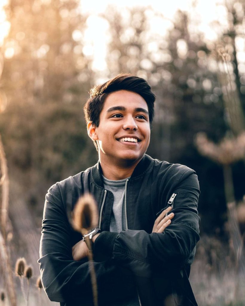 A man standing in a field who is happy after finishing psycholgy therapy