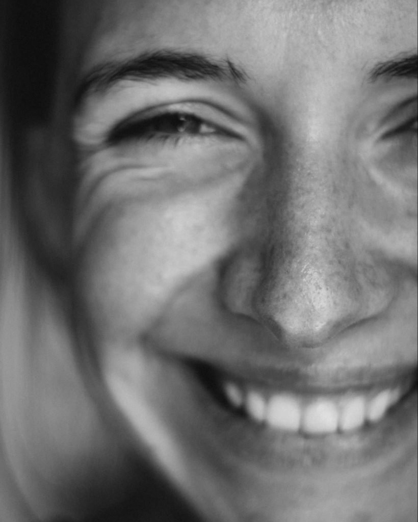 Close up of a happy woman after receiving psychological therapy in black and white